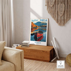 Keswick Poster showcasing a colorful boat on a peaceful lake with autumn foliage in the background.
