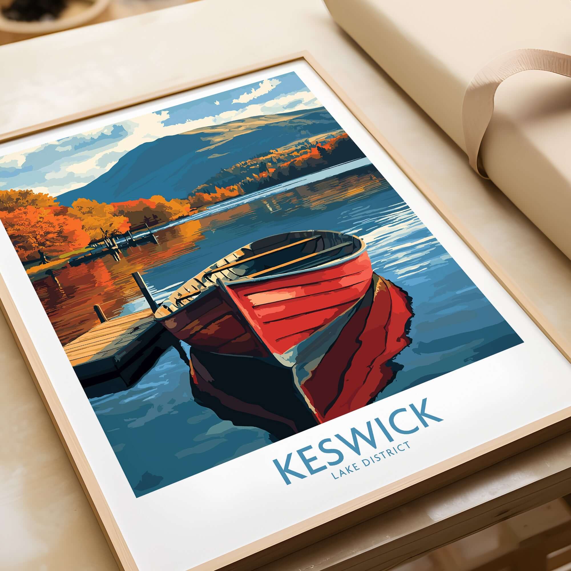 Keswick Poster featuring a red boat on a tranquil lake in the Lake District, capturing autumn's beauty.