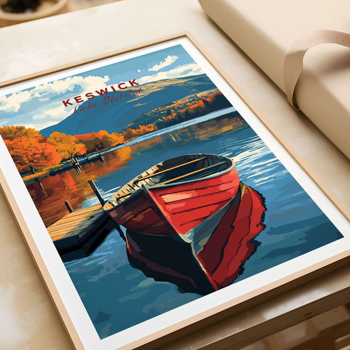 Keswick Print showcasing a red boat on a serene Lake District scene with vibrant autumn colors and mountains.