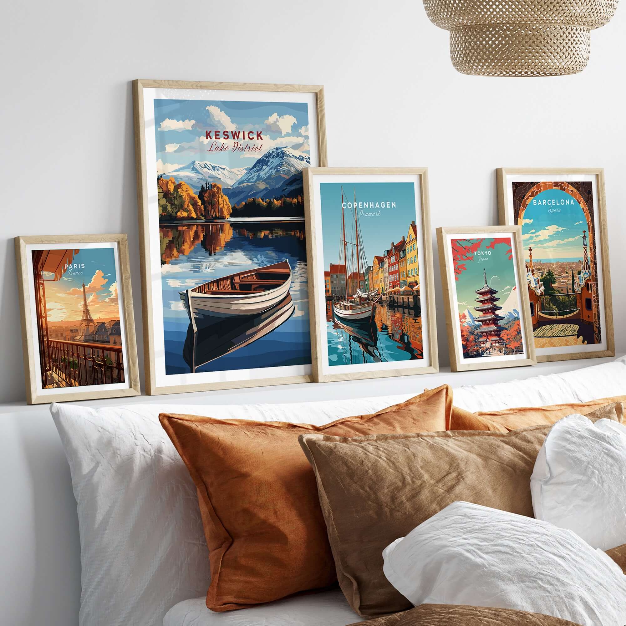 Framed Keswick Print Lake District artwork displayed on a wall with various travel prints and cozy cushions.