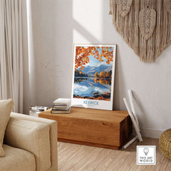 Keswick Travel Poster showcasing autumn scenery in the Lake District, placed in a cozy room setting.