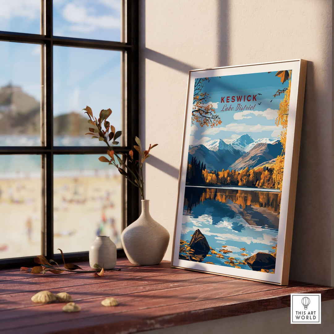 Keswick Wall Art showcasing a serene Lake District landscape, framed and placed on a sunny windowsill.