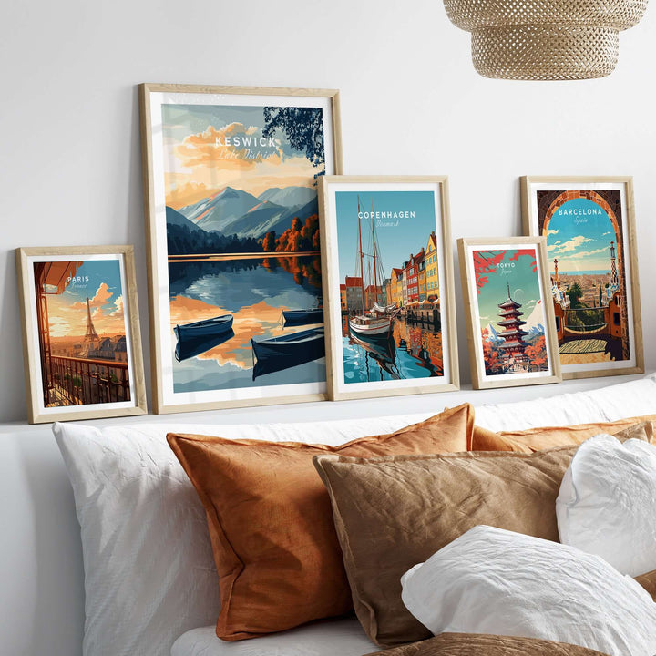 Keswick wall art poster featuring Lake District scenery, surrounded by framed city posters on a stylish bed.