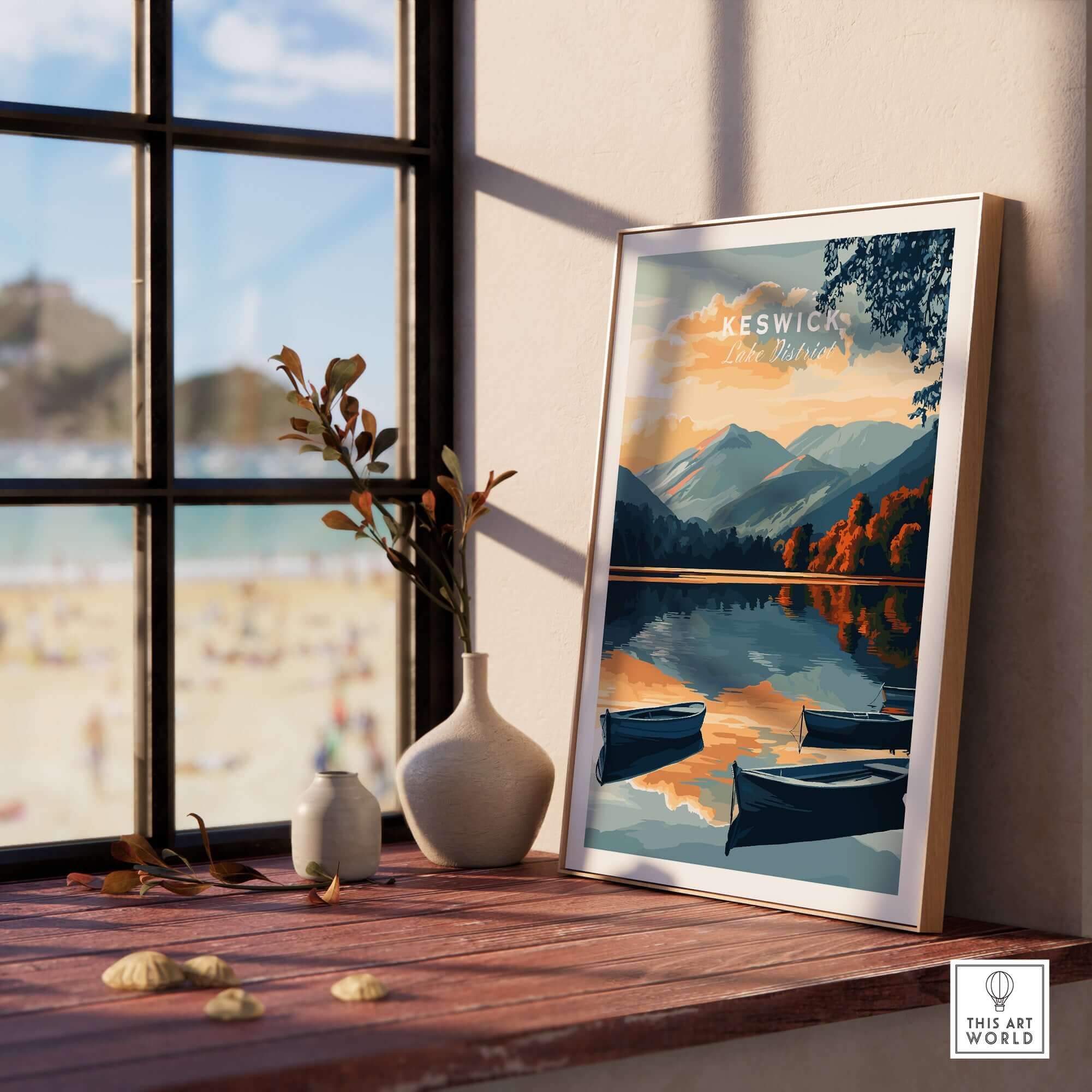 Keswick Wall Art Poster displayed on a wooden shelf with mountains and lake reflecting in the background.