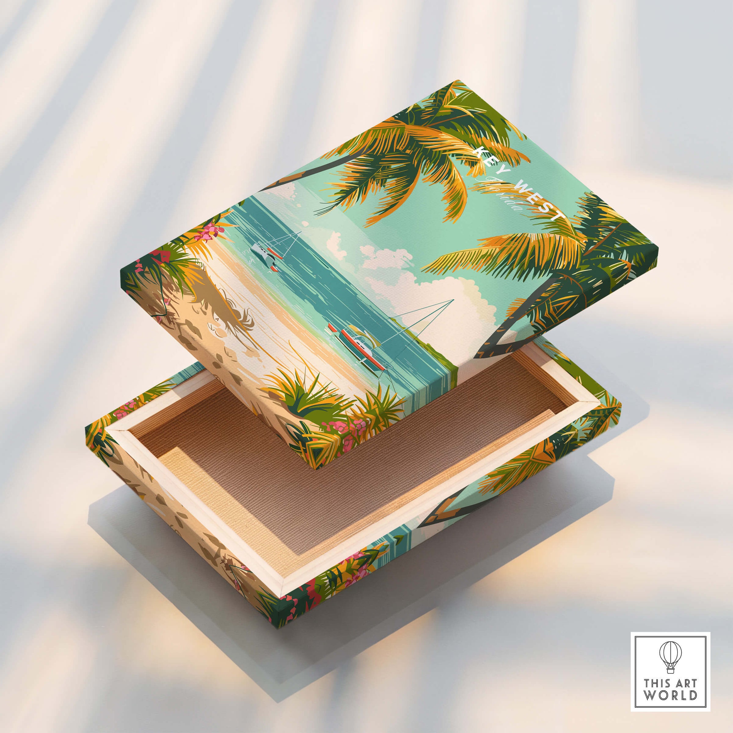 Key West Travel Poster design on a decorative box showcasing tropical beach scene with palm trees and people.