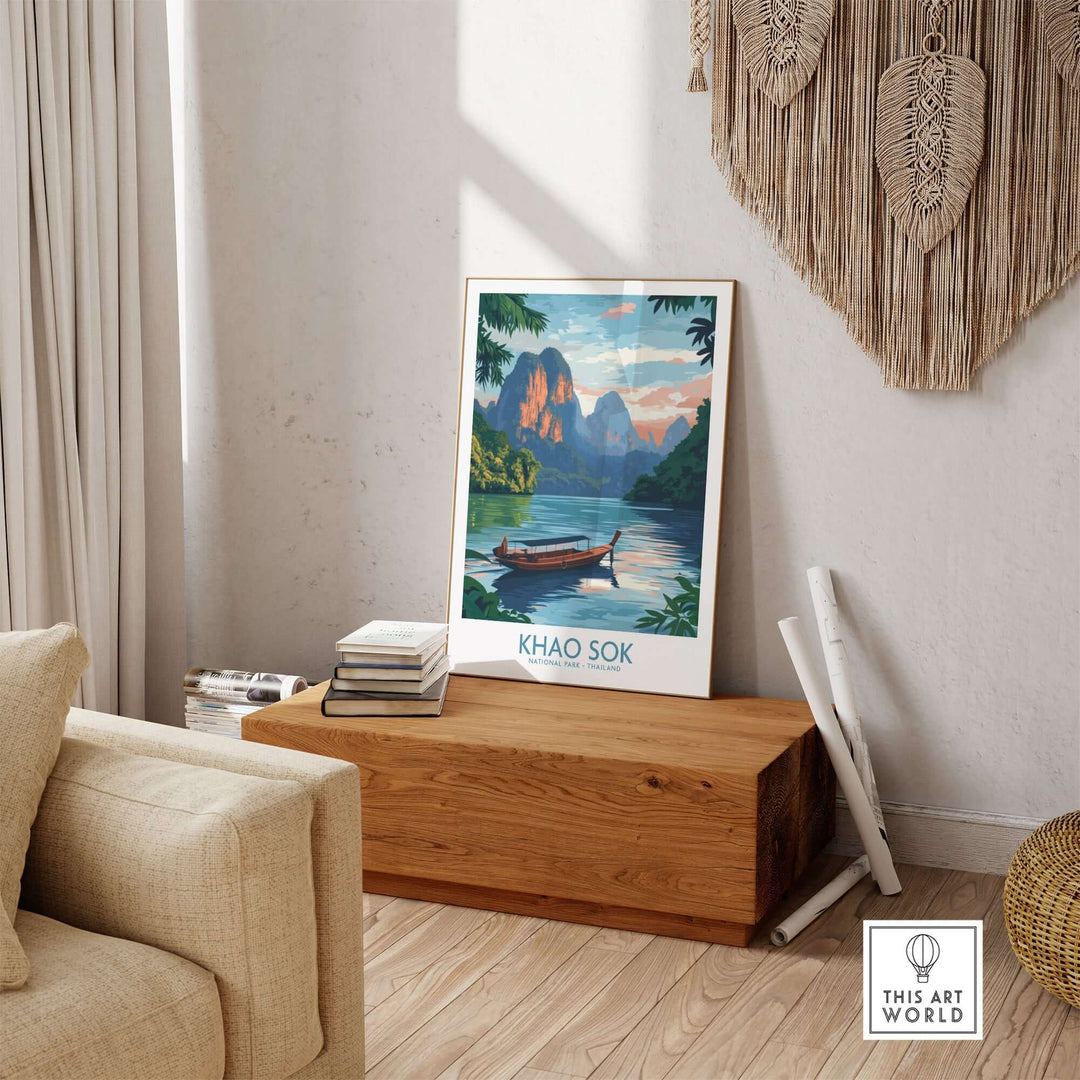 Khao Sok poster featuring a serene landscape with mountains and a tranquil boat scene, displayed in a cozy interior.