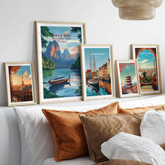 Framed Khao Sok Print alongside other city prints on a cozy bed setting, showcasing nature and adventure.