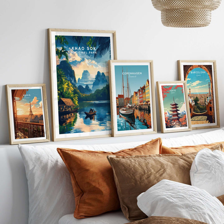 Khao Sok travel print displayed with other city art prints on a stylish shelf above a cozy sofa.