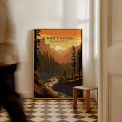 Framed Kings Canyon National Park travel poster leaning on floor, man walking past in hallway.