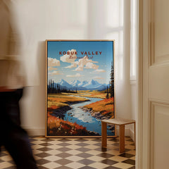Framed Kobuk Valley National Park travel poster with mountains and river, leaning on wall