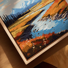 Close-up of framed canvas art with river landscape, autumn colors, and natural wood frame.