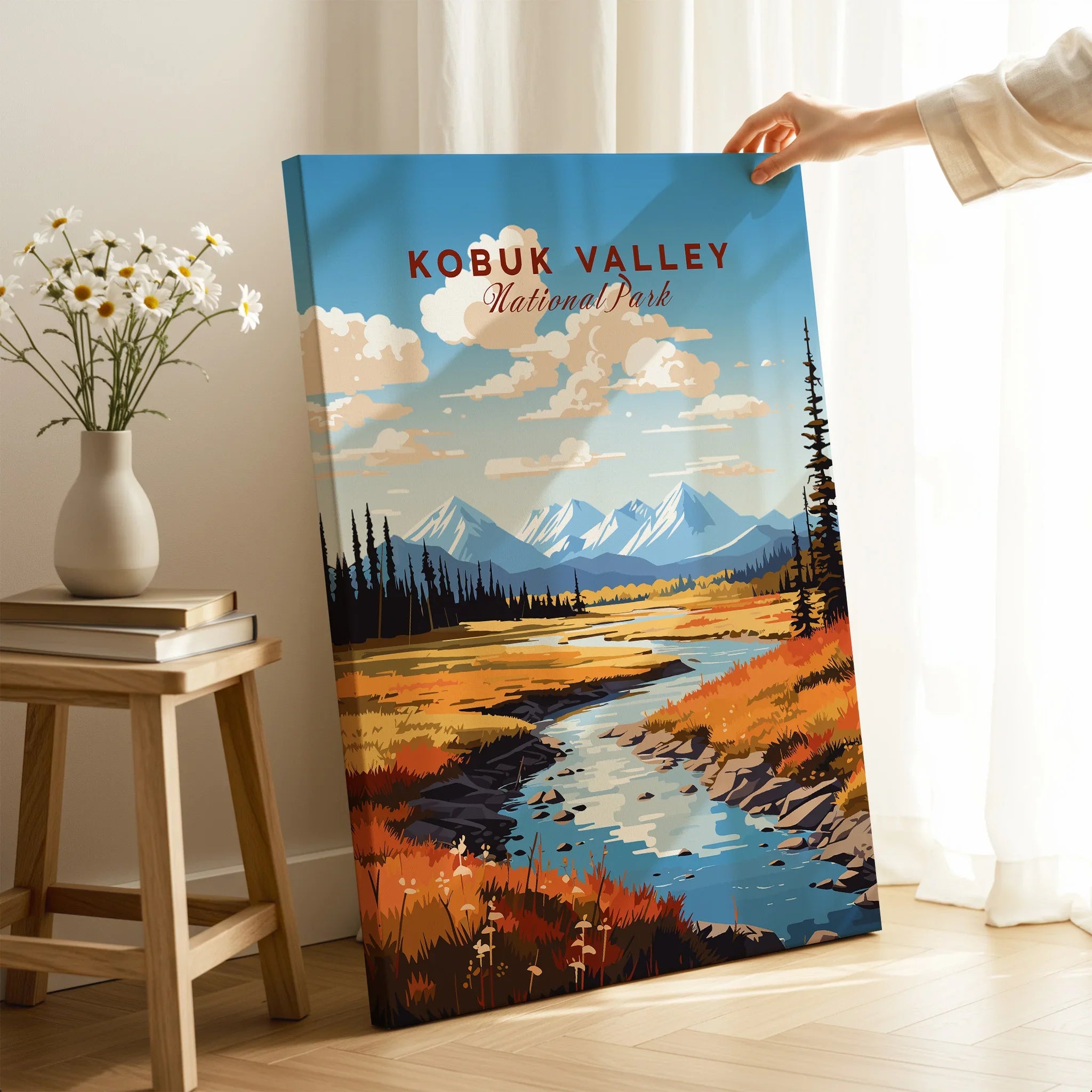 Kobuk Valley National Park canvas print with mountain landscape, hand holding it in a bright room