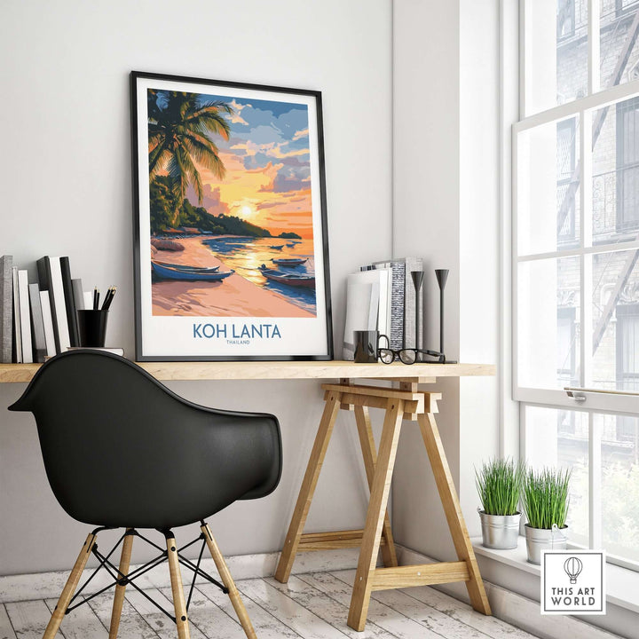 Koh Lanta travel poster featuring a serene beach scene and sunset, displayed in a stylish workspace.