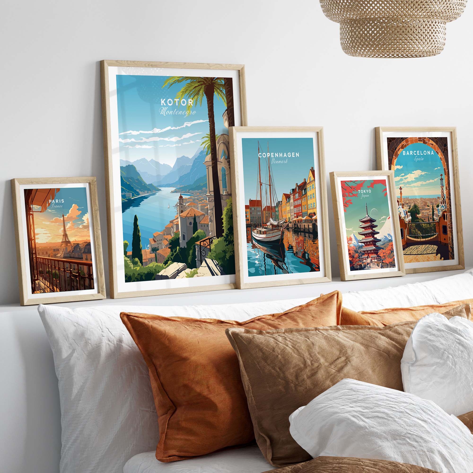 Gallery wall featuring Kotor Montenegro print and travel posters of Copenhagen and Barcelona in a cozy home setting.