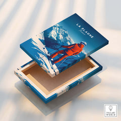 La Plagne Travel Poster artwork on a wooden box showcasing a skier against a snowy mountain backdrop.