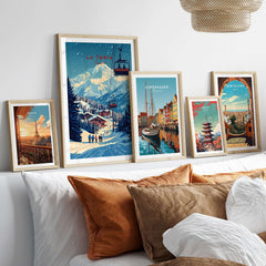La Tania Wall Art Ski Print displayed among other city-themed prints on a cozy bed with decorative pillows.