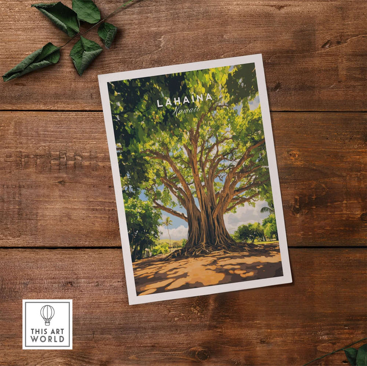 Lahaina Banyan Tree poster resting on wooden surface with lush green branches and blue sky background.