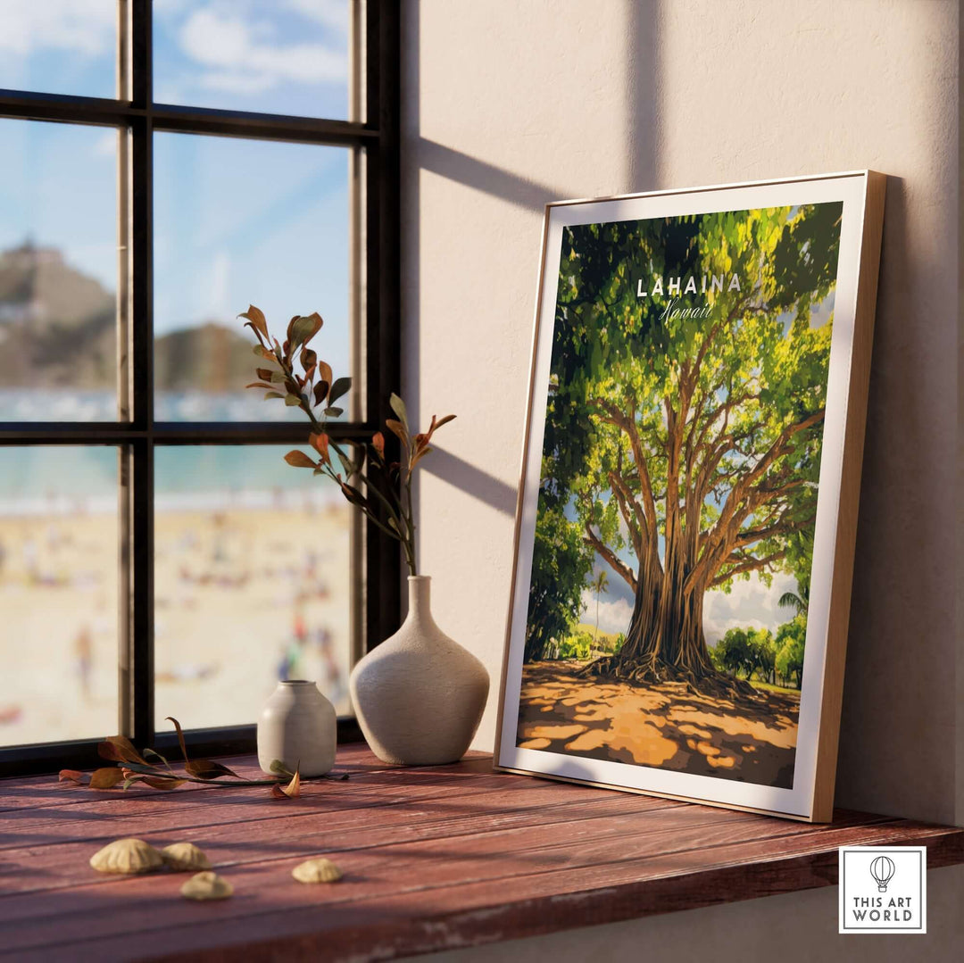 Lahaina Banyan Tree poster displayed on a windowsill, showcasing vibrant artwork and coastal scenery.