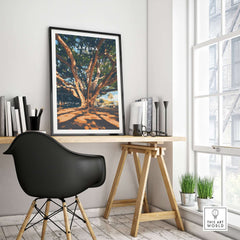 Lahaina Travel Print showcased on a stylish desk, featuring a majestic banyan tree and vibrant colors.
