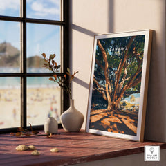 Lahaina Travel Print displayed by a window, featuring a majestic banyan tree in vibrant colors.
