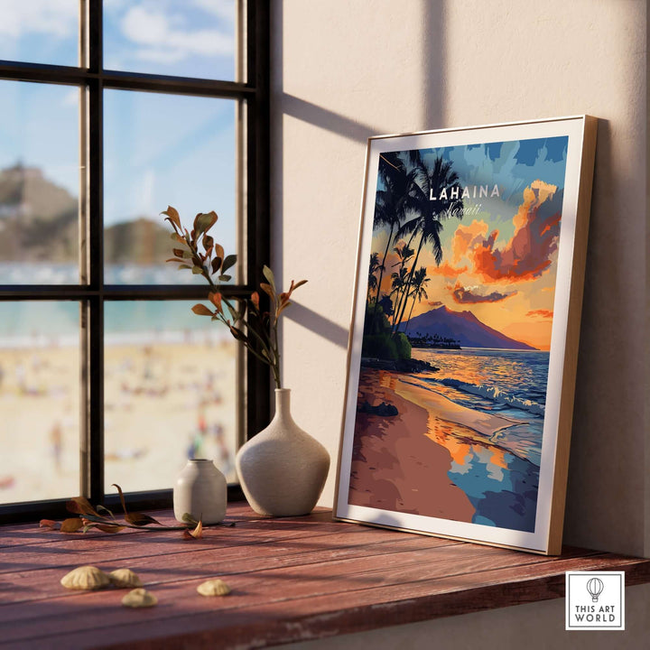 Lahaina wall art featuring a colorful sunset over the beach, framed and displayed indoors, capturing Hawaii's natural beauty.