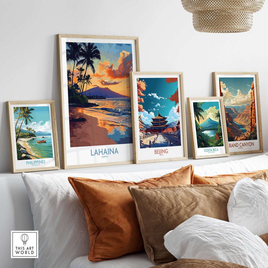 Lahaina wall art print displayed with framed art from various locations on a stylish couch.