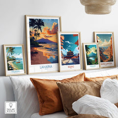 Lahaina Wall Art Print displayed among framed coastal landscape art on a cozy sofa, showcasing vibrant colors and tranquil scenes.