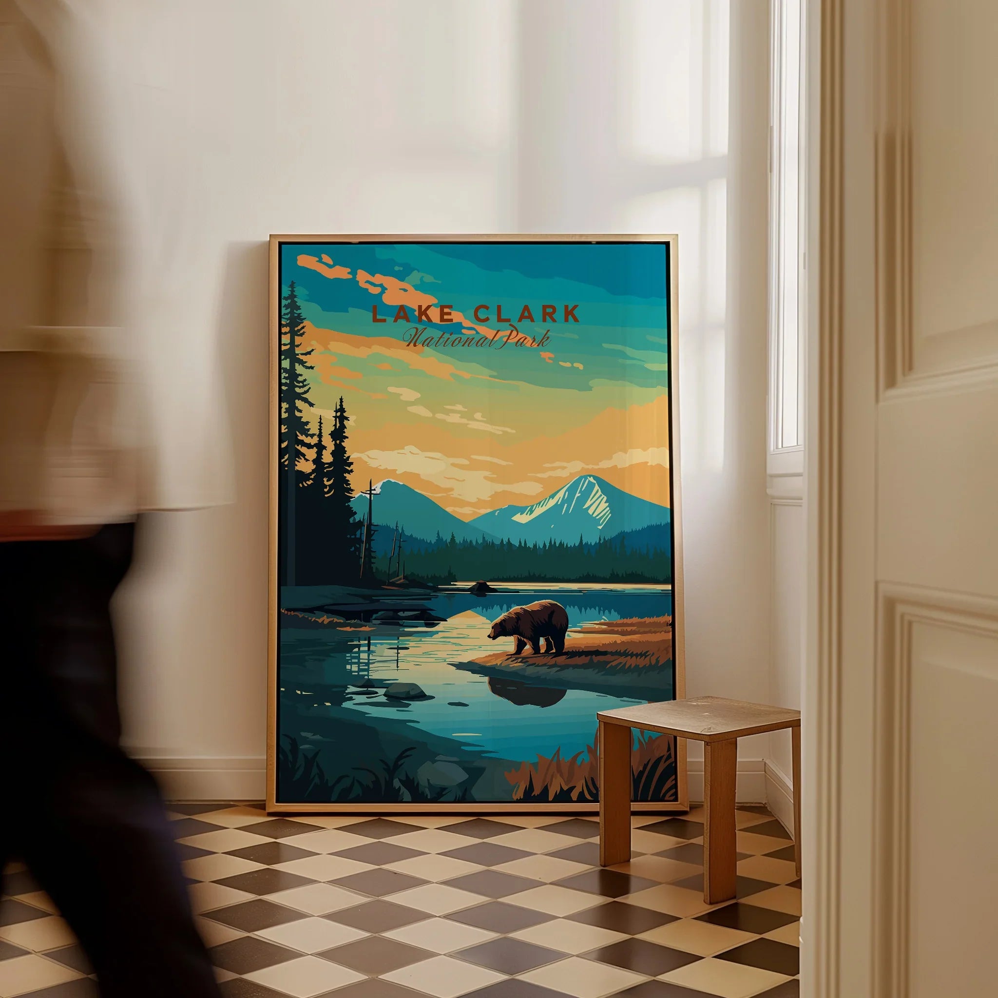 Framed Lake Clark National Park travel poster with bear, mountains, and river on checkered floor.