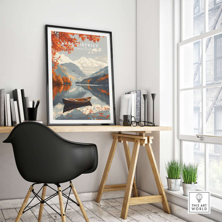 Lake District England travel poster featuring autumn scenery with a boat on serene waters in a stylish home office setup.