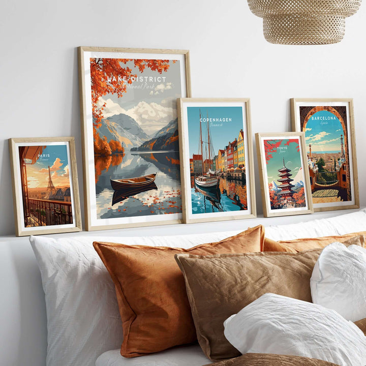 Lake District England travel poster displayed among other city travel posters in a cozy home setting.