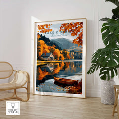 Lake District Poster showcasing autumn scenery with a cabin and reflections on the water.