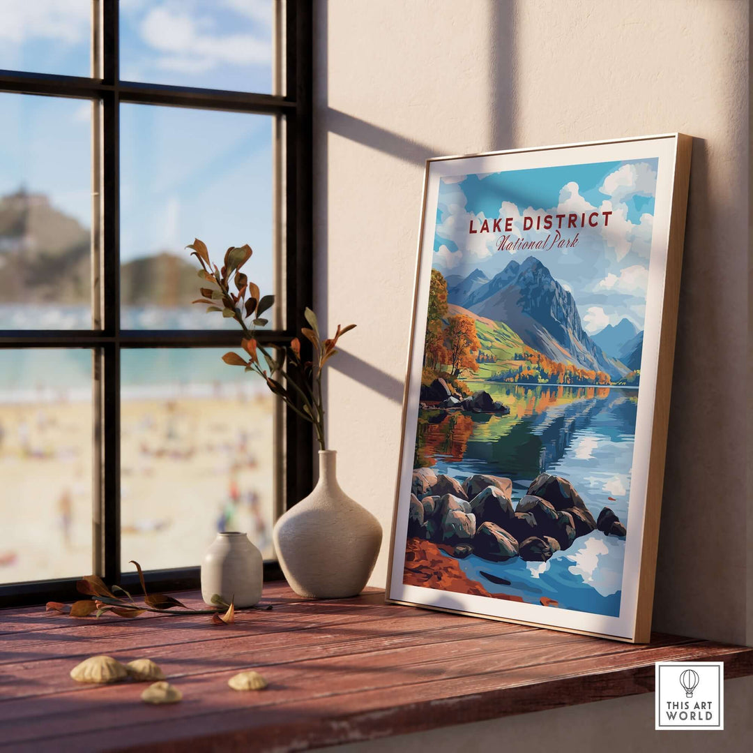 Lake District travel print displayed on a wooden table beside a window, capturing stunning landscapes and serene nature.