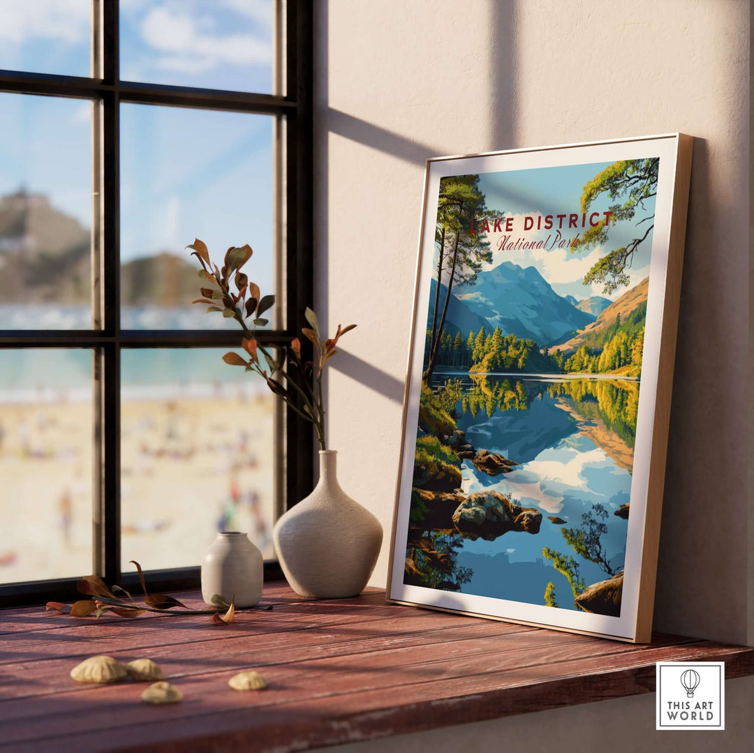 Lake District wall art displayed on a wooden table by the window, showcasing serene mountain and lake scenery.