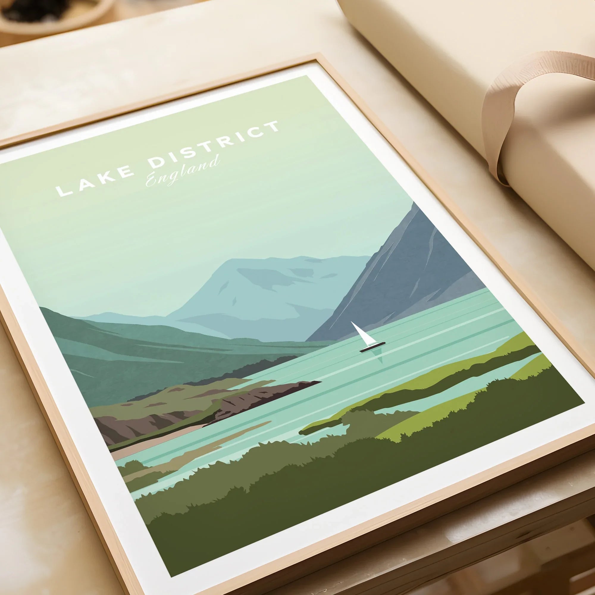 Lake District England travel poster with sailboat, mountains, and green landscape in wooden frame