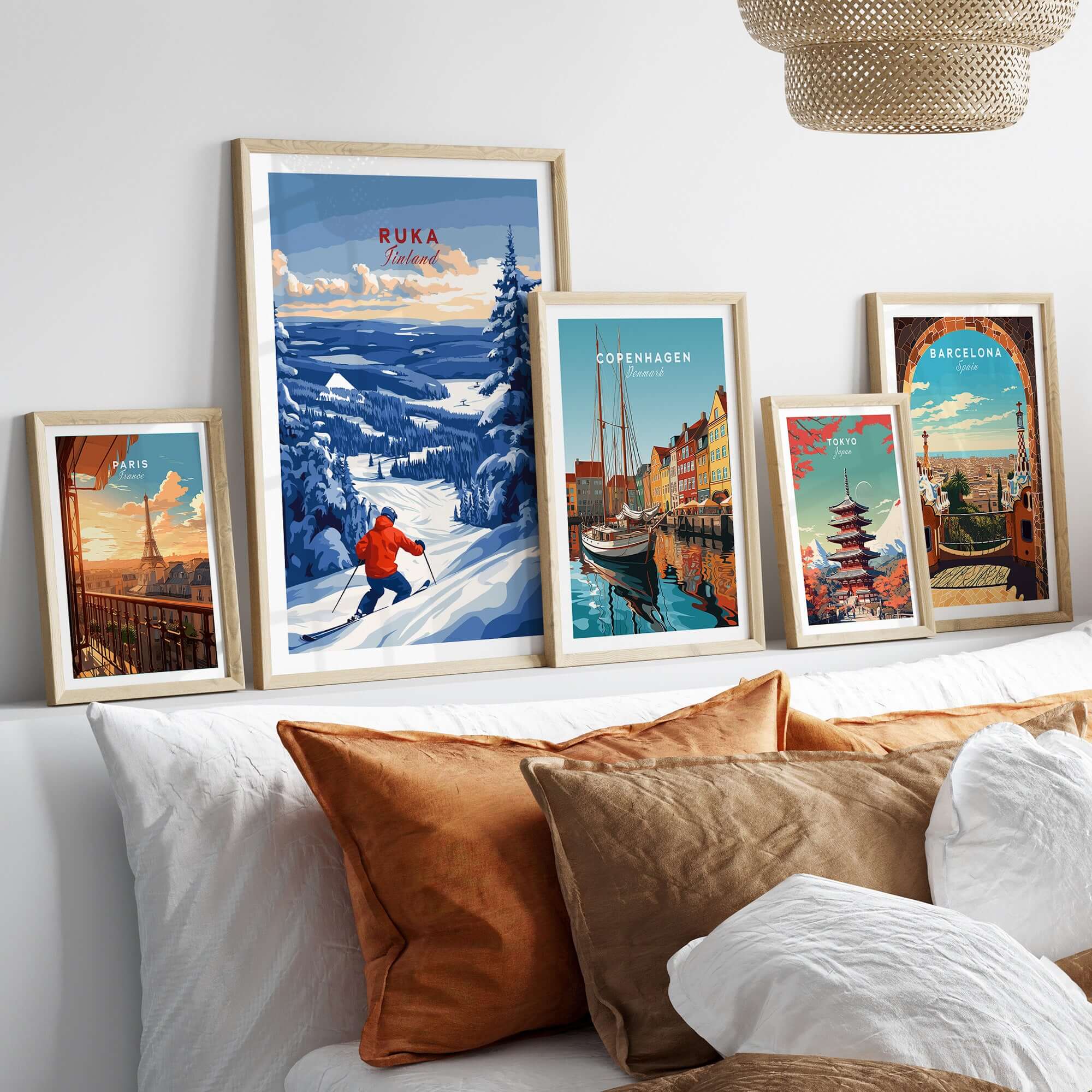 Lapland ski landscape art prints on a wall, featuring Ruka Finland, Copenhagen, and Barcelona scenes.