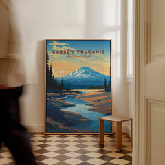 Framed Lassen Volcanic National Park poster on floor with a man walking past in a bright hallway.