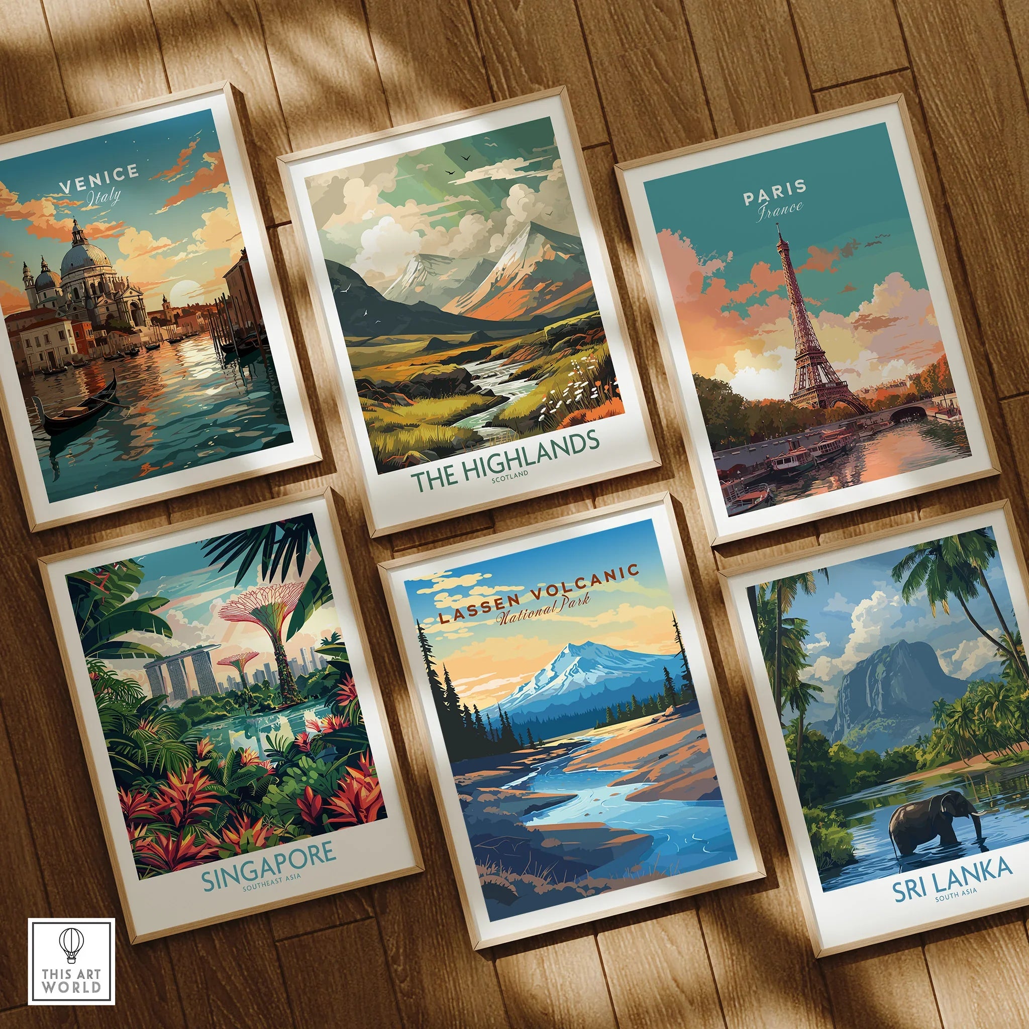 Set of six framed travel and national park art prints on wooden floor, including Venice, Paris, The Highlands, Singapore, Lassen Volcanic, and Sri Lanka.
