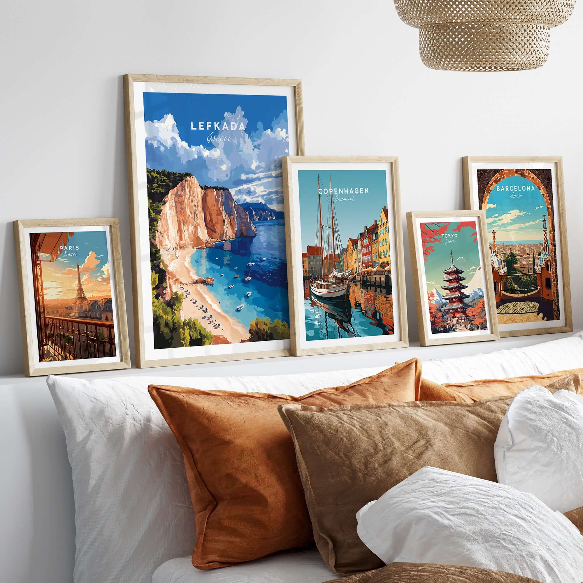 Lefkada Print Greece collection displayed on a stylish couch, showcasing stunning travel art of Greece and other cities.