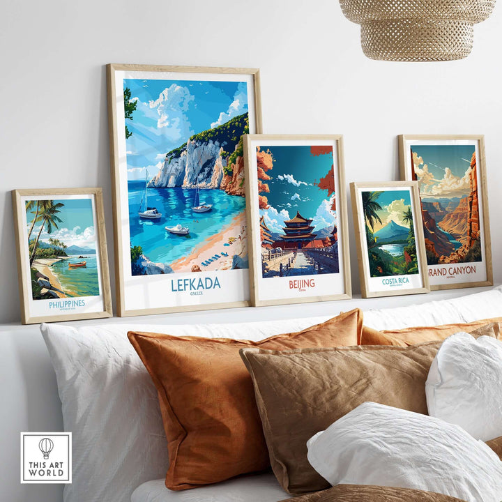 Stylish travel posters on a wall, featuring Lefkada, Beijing, Costa Rica, Philippines, and Grand Canyon.