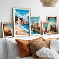 Lefkada Wall Art displayed on a wall with framed prints of beach scenes and city landscapes.