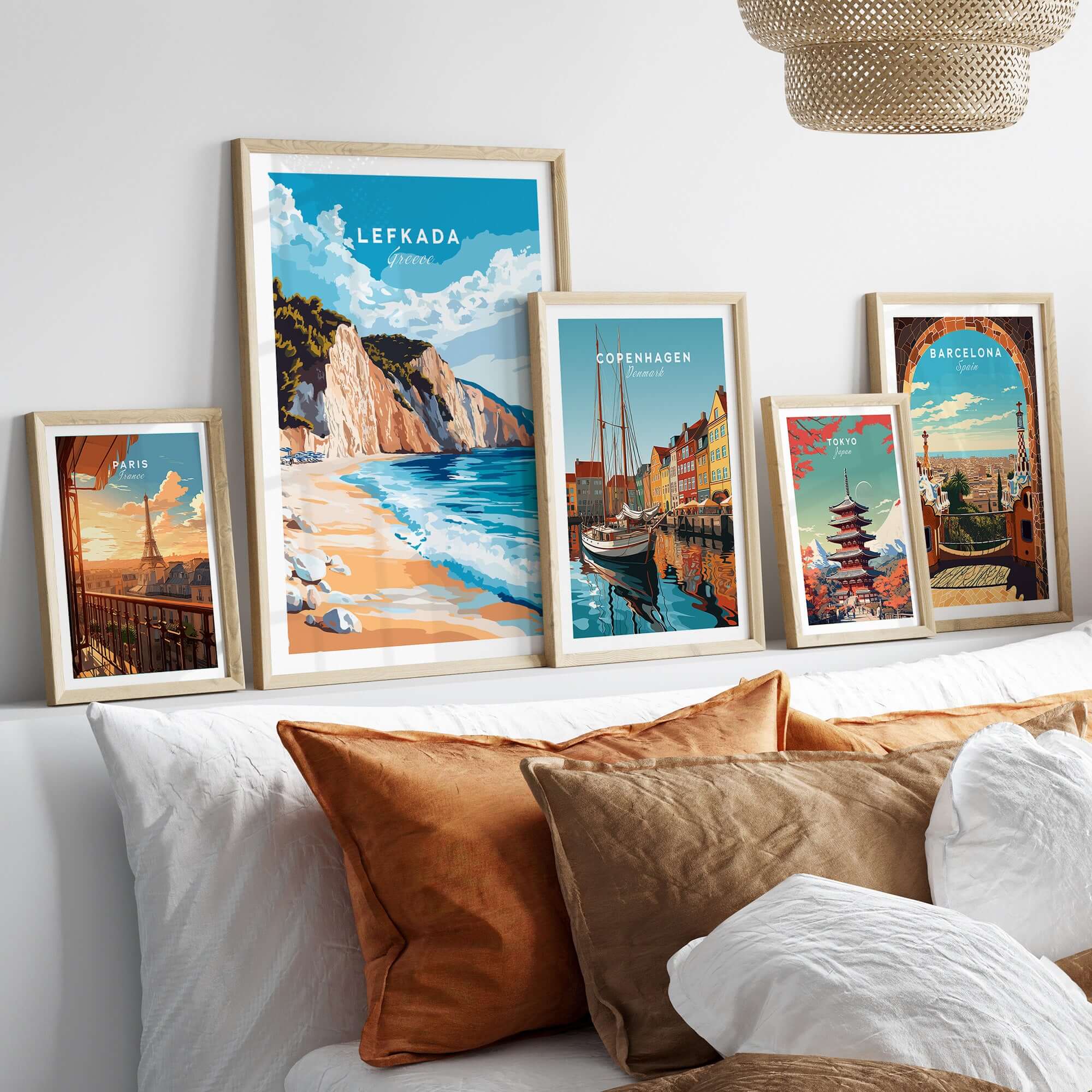 Lefkada Wall Art displayed on a wall with framed prints of beach scenes and city landscapes.
