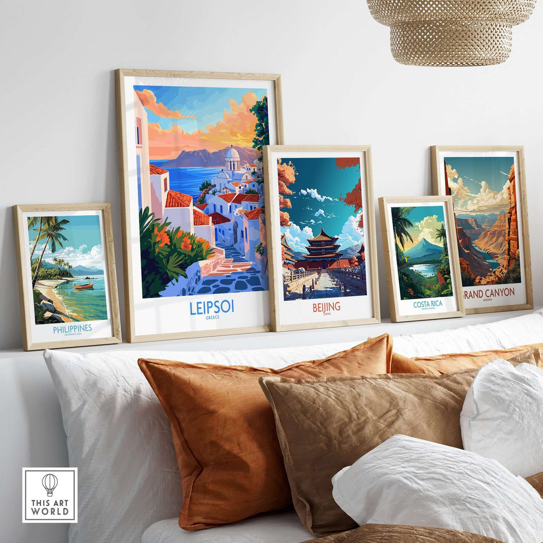 Leipsoi travel poster and other travel posters displayed on a wall above a cozy sofa with decorative pillows.