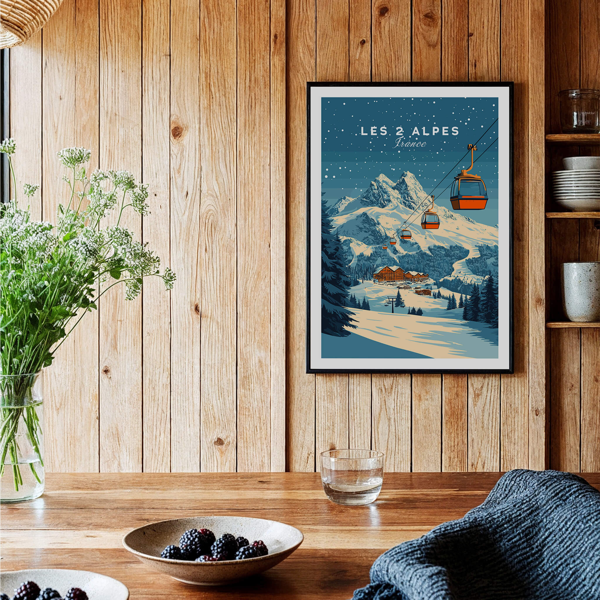 Les 2 Alpes Ski Print displayed in a cozy interior with wooden walls and fresh flowers.