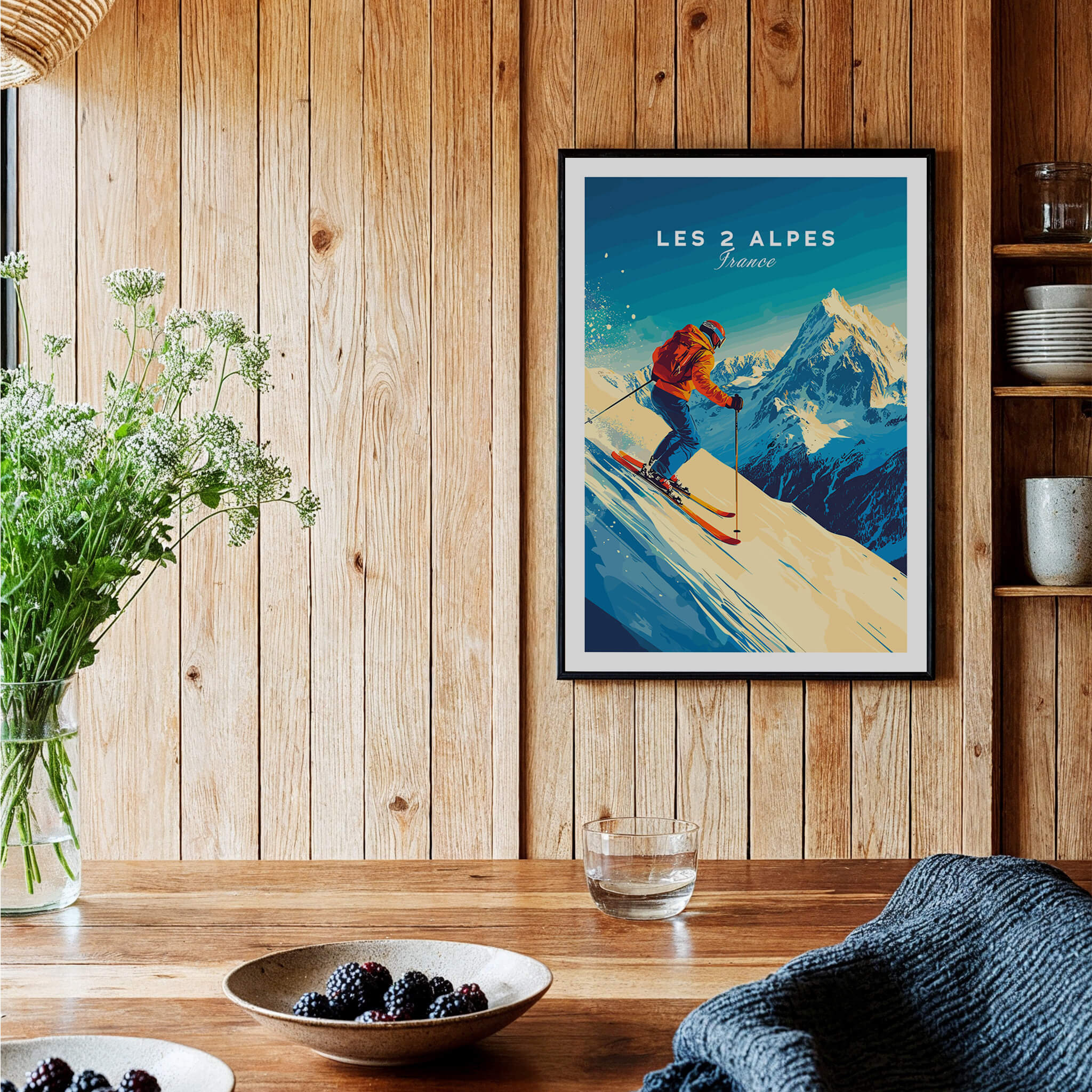 Les 2 Alpes Wall Art Ski Print framed on a wooden wall with a skier and mountain scenery.
