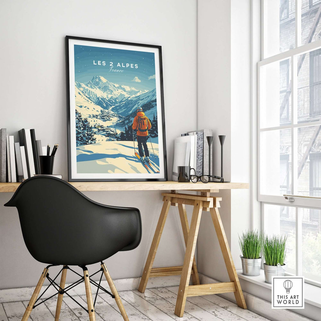 Ski art print of Les 2 Alpes, France, displayed in a modern home office setting with a stylish chair and desk.