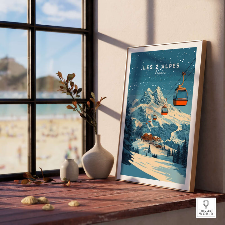 Les 2 Alpes ski print displayed on a windowsill, showcasing winter scenery and ski lifts, perfect for adventurous home decor.