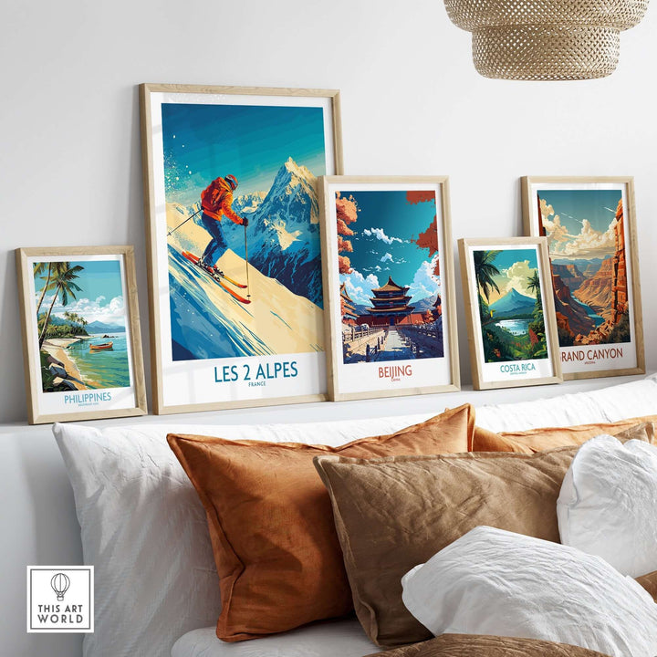 Les 2 Alpes wall art poster with skiing design among other travel-themed framed posters on a stylish sofa.