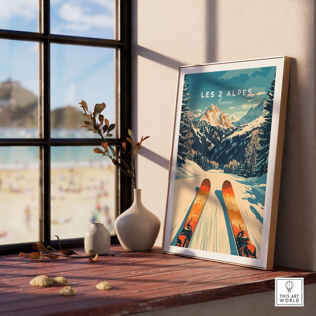 Les 2 Alpes ski poster framed on a sunny windowsill, showcasing vibrant slopes and mountains, perfect for ski lovers.