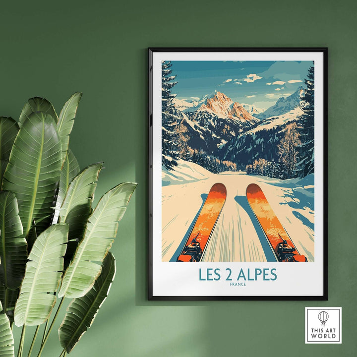 Les 2 Alpes wall art print featuring a skier on snowy slopes, framed against a green wall and tropical plant decor.