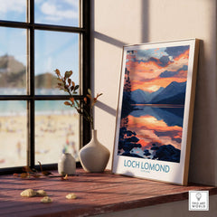 Loch Lomond Art Print displayed on a windowsill, featuring a scenic sunset over the lake in Scotland.